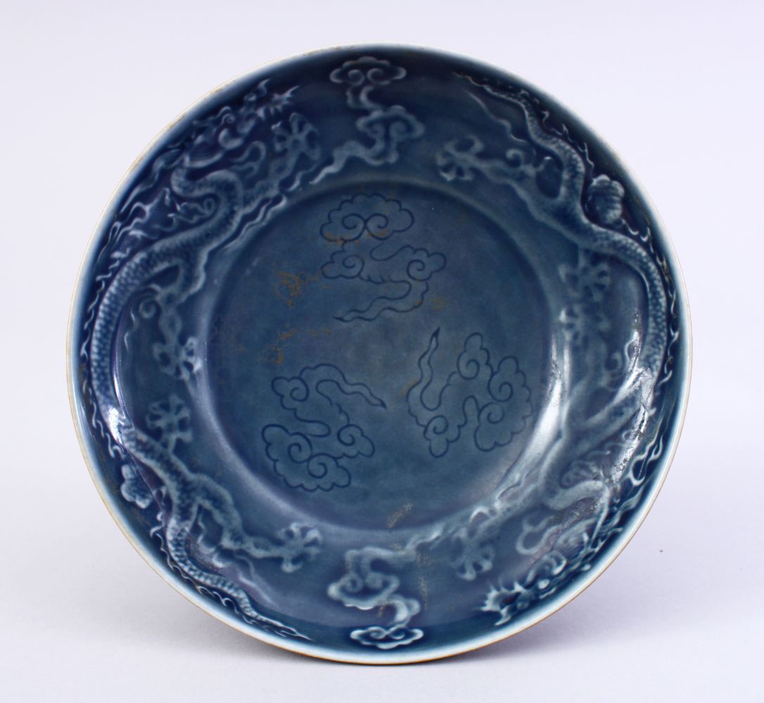 A GOOD EARLY MING OR LATER DRAGON PORCELAIN DISH, The interior of the dish decorated with scenes