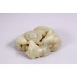A SMALL CHINESE CARVED JADE GROUP of three rams, in a fitted box.