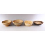 A GROUP OF FOUR EARLY CHINESE EARTHENWARE CIRCULAR BOWLS, various sizes.