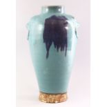 A CHINESE PURPLE SPLASH POTTERY VASE, with moulded lion mask handles, 35cm high.