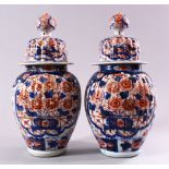 A PAIR OF JAPANESE MEIJI PERIOD IMARI PORCELAIN VASES AND COVERS, with ribbed body's, and panels
