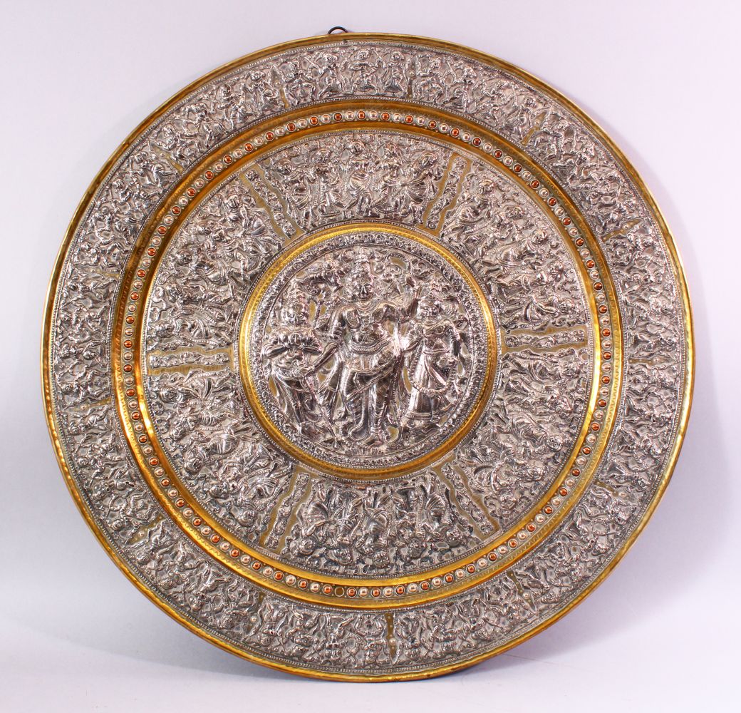 A LATE 19TH CENTURY INDIAN TANJORE SILVER AND COPPER EMBOSSED BRASS TRAY/PLAQUE, decorated with