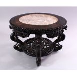 A GOOD CHINESE CARVED HARDWOOD STAND, with inlaid marble top, 22cm high, 30cm diameter.
