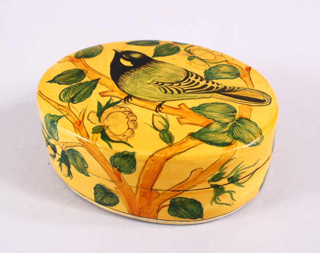 A 19TH / 20TH CENTURY PERSIAN LACQUER LIDDED BOX, decorated with birds and flora, 9cm