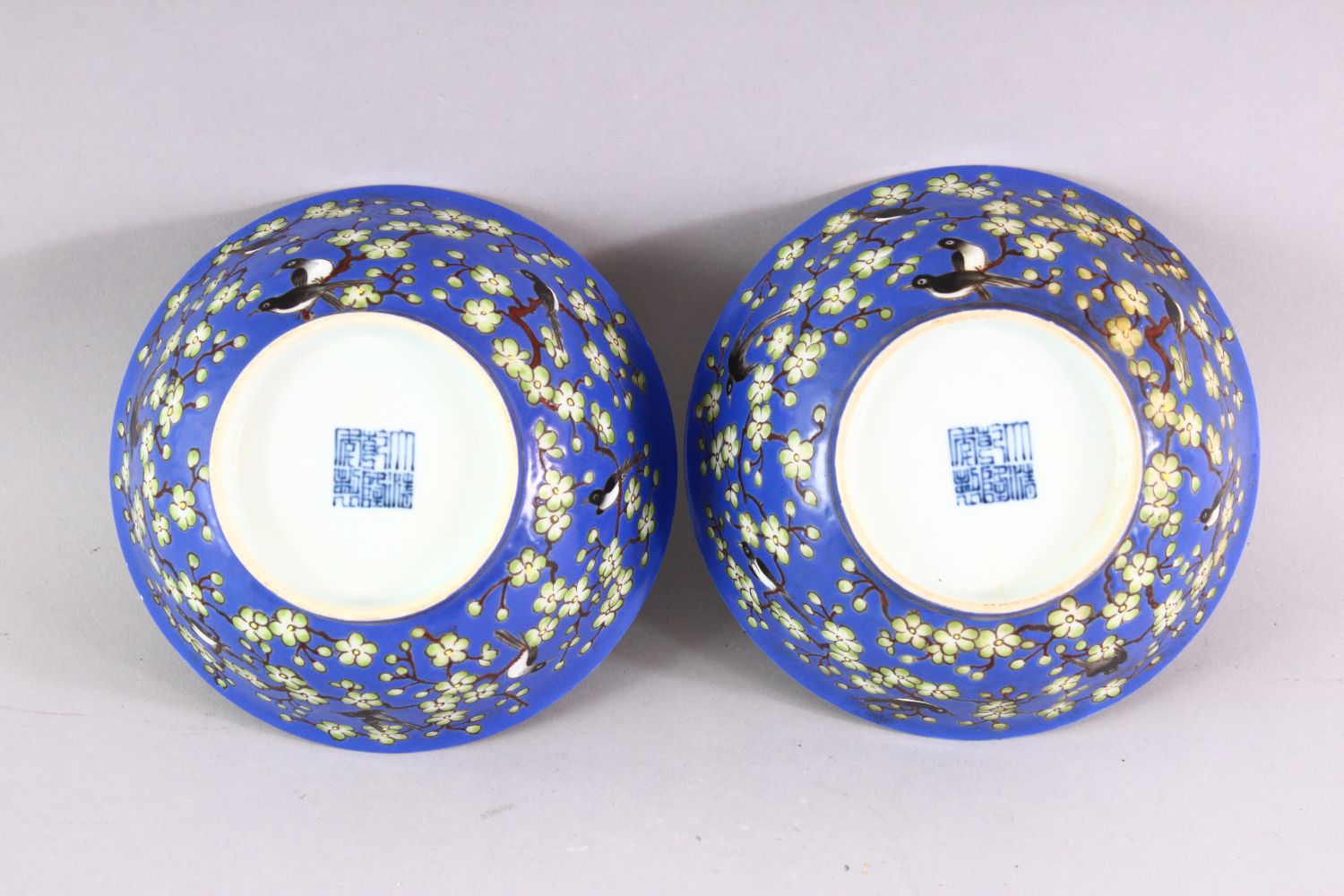 A PAIR OF CHINESE BLUE GROUND PORCELAIN BOWLS, each decorated with birds perched on blossoming - Image 3 of 5
