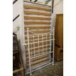 A Victorian style white painted cast iron single bed frame with mattress.