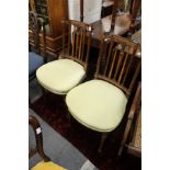 A good pair of Edwardian mahogany and satinwood inlaid bedroom chairs.