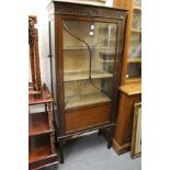 A mahogany standing display cabinet.