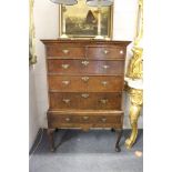 A good 18th century chest on stand, possibly mulberry wood veneered, the sides elm, comprising two
