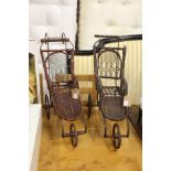 Two old fashioned style miniature invalid carriages.