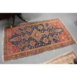 A Persian rug, blue ground with geometric decoration.