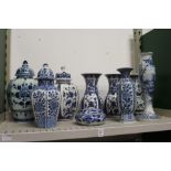 A quantity of Dutch Delft blue and white jars and covers, vases etc.