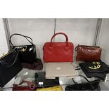 A Radley red leather handbag and three other bags.