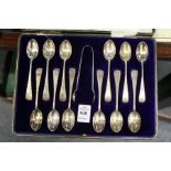 A cased set of twelve bright cut silver coffee spoons with sugar nips, London 1884.