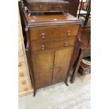 A mahogany gramophone style music cabinet.