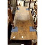 An oak rectangular drop leaf gate leg dining table on turned legs with pad feet.