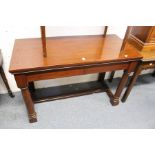 A mahogany console table with two frieze drawers on gun barrel turned front legs united by an H-
