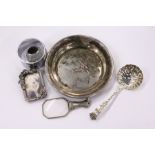 A small silver handled magnifying glass and other items.