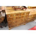 An 18th century walnut chest of two short and three graduated long drawers (top stripped and re-