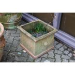 A large square shaped terracotta garden planter.