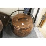 A good large copper cooking pot with wrought iron handle (associated lid).