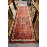 A red ground Hamadan runner / hall carpet.