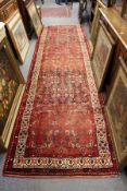 A red ground Hamadan runner / hall carpet.