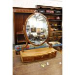A mahogany bow fronted dressing table mirror.