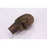 A small carved wood okimono of a head.