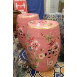 An unusual pair of Chinese barrel seats, pink ground with floral decoration.