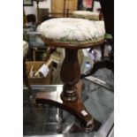 A 19th century mahogany revolving piano stool.