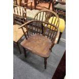 A 19th century ash elm and yew low Windsor armchair.