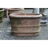 A good large oval terracotta planter with moulded decoration, stamped with a manufacturer's name.