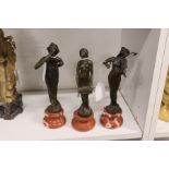 Three small Art Nouveau style bronze figures of ladies on marble bases.