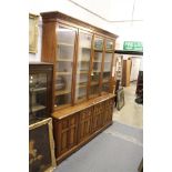 A good 19th century oak library cupboard bookcase with dentil moulded cornice, four glazed doors