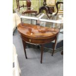 A mahogany D-shaped foldover card table with a single drawer on tapering square legs.