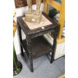 A Chinese carved hardwood two tier marble top stand.