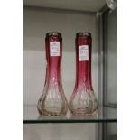 A pair of silver topped pink and clear glass vases.
