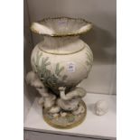 A gilt decorated Parian style jardiniere modelled as "merchildren" holding alft a vase (AF).