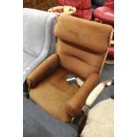 A Charles Eames style moulded plywood and upholstered swivel armchair.