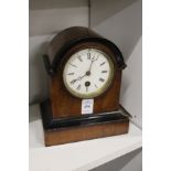 A mahogany mantle clock.