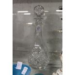 A cut glass decanter.