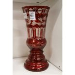 A Bohemian red tinted glass vase with engraved decoration.