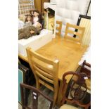 A good modern light oak rectangular dining table with six ladder back chairs.