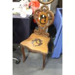 A Black Forest carved and inlaid walnut hall chair.