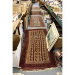 Four small Persian Baluch rugs.