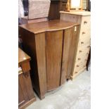 A mahogany bow fronted two door cabinet.