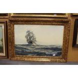 A Galleon at Sea colour print in a decorative gilt frame.