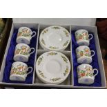 A set of six Aynsley Cottage Garden coffee cans and saucers, boxed.