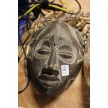 A good carved wood mask with beaded hair.